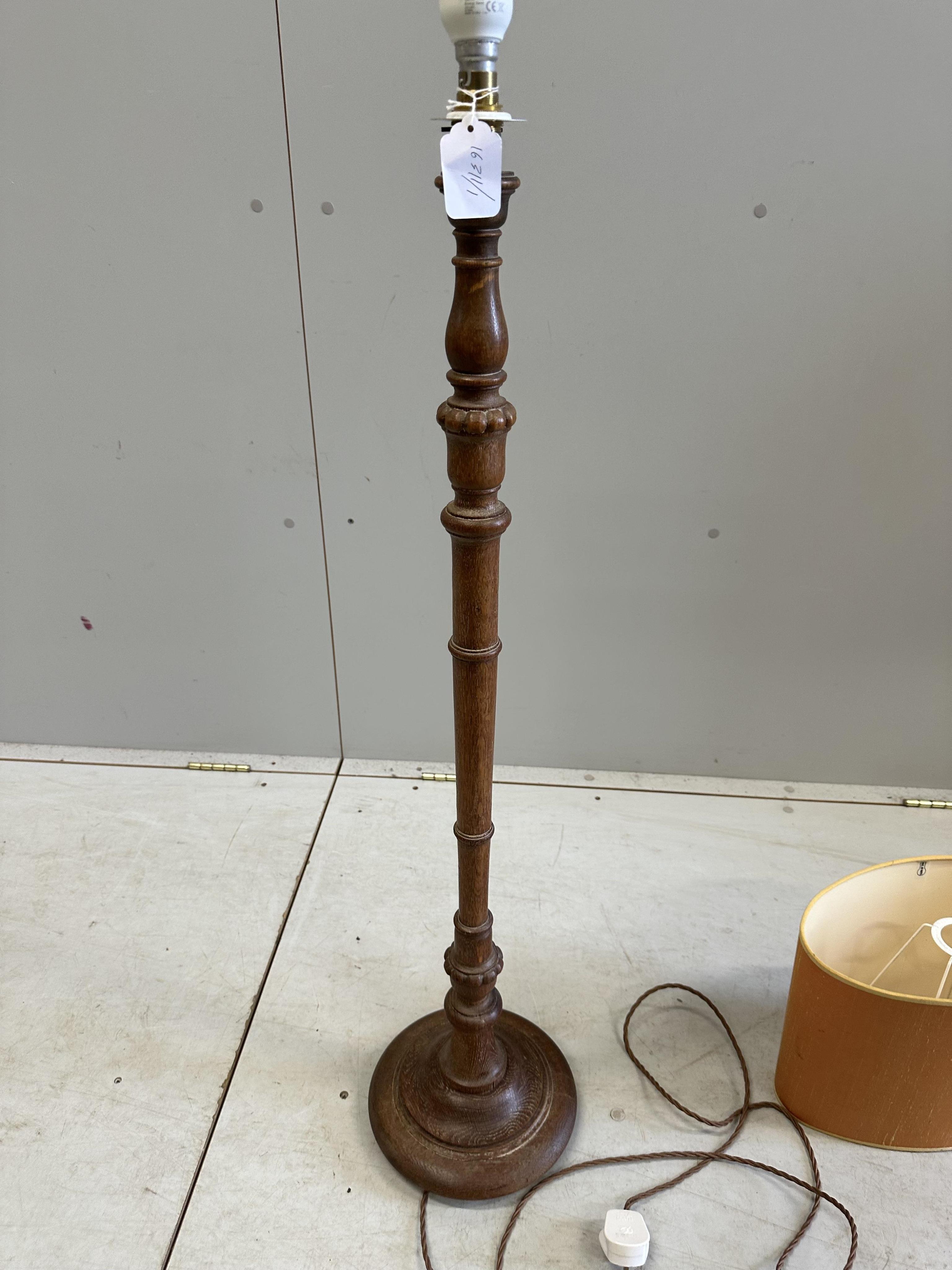 A 1930's turned oak standard lamp, height 97cm plus shade. Condition - good